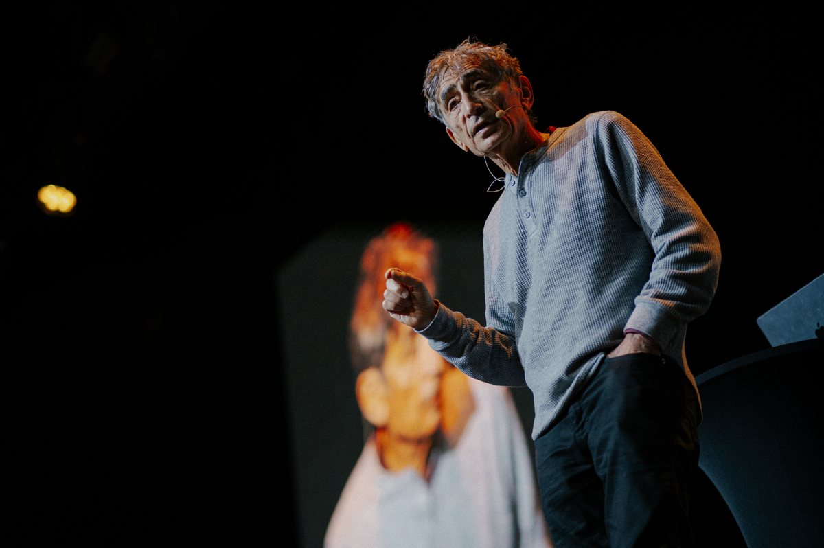 Gabor Maté speaking on stage at an OMEA co-created event